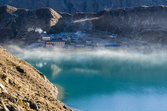 Morning mist over the lake and village of Gokyo at sunrise