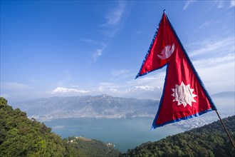 Nepali national flag waving high above the Phewa Lake and Pokhara