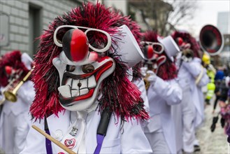 People wearing fancy dresses and masks at the great procession of the Carnival of Basel