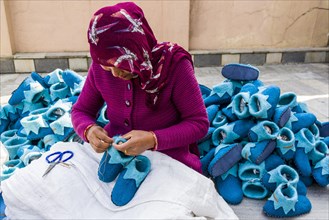 Woman working on felt shoes
