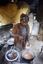 Woman is cooking in a simple kitchen
