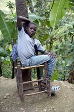 Teenager boy on a rickety chair