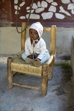 Toddler sitting on a chair