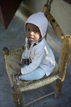 Toddler sitting on a chair