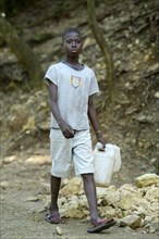 Boy with empty cans to fetch water