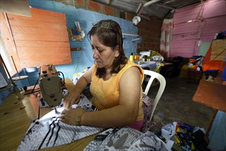 Seamstress in Comuna 8 slum