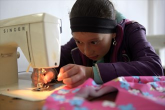 Girl using sewing machine