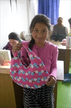 Girl proudly displaying her homemade bag