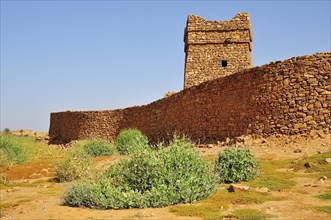 City walls and minaret of the fortified trading post or Ksar