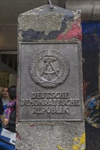 Old concrete pillar of the Inner German border with sign Deutsche Demokratische Republik or German Democratic Republic
