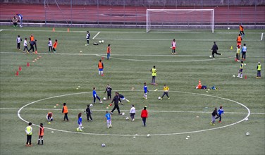 Children in colorful clothes on a sports field