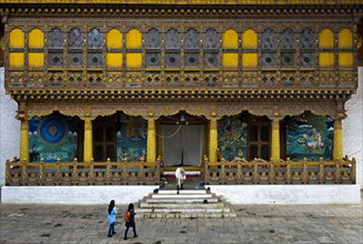 Tourists at the entrance to the coronation temple in the monastery fortress Punakha Dzong
