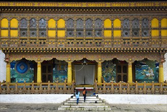 Tourists at the entrance to the coronation temple in the monastery fortress Punakha Dzong
