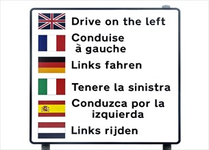Multilingual warning sign for tourists lettering Drive on the left