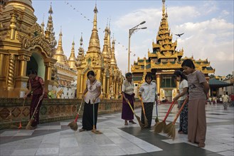 Women sweeping the floor at the site of the Shwedagon Pagoda