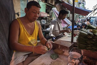 Man preparing betel nut for sale