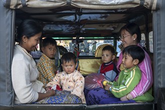 Local women and children sitting in a vehicle