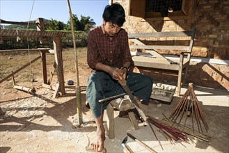 Local man making an umbrella in an umbrella factory