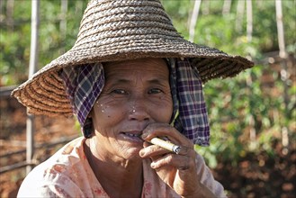 NLocal woman with typical hat smoking a cigar