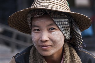 Native Woman with typical hat and Thanaka paste on the face