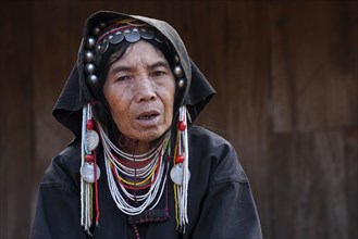 Old local woman from the tribe of the Akha with typical headgear