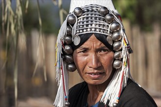 Old local woman from the tribe of the Akha with typical headdress
