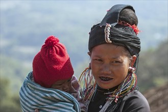 Native young woman with young child in typical clothing