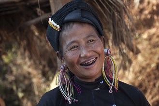 Native woman in typical clothing and headgear from the Ann tribe in a mountain village at Pin Tauk