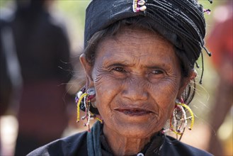 Native woman in typical clothing and headgear from the Ann tribe in a mountain village at Pin Tauk