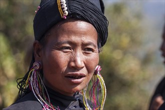 Native woman in typical clothing and headgear from the Ann tribe in a mountain village at Pin Tauk