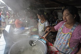 Local women preparing food at food stalls in the market
