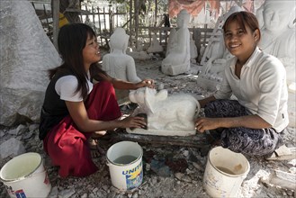 Native girls cleaning a finished marble figure