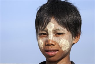 Local boy with Thanaka paste on his face