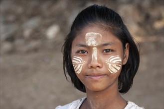 Local girl with Thanaka paste on her face