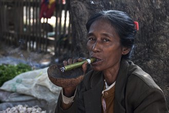 Native woman smoking a Cheeroot cigar