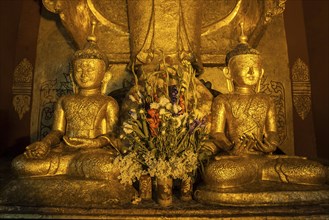 Two seated gilded Buddha statues