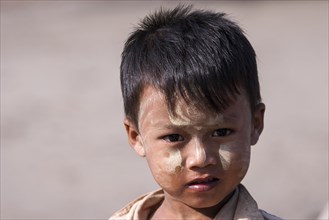Local boy with Thanaka paste on his face