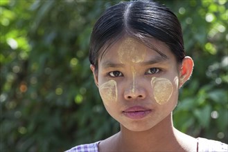 Young woman with Thanaka paste on her face