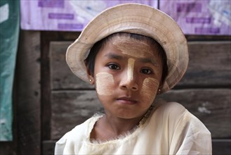 Native girl with Thanaka paste on her face