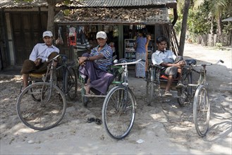 Native rickshaw drivers sitting on their rickshaws
