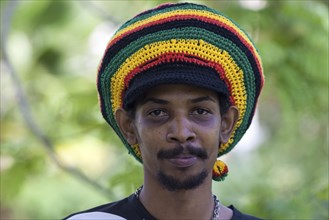 Indigenous man with a colorful Rastafarian hat