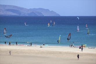 Windsurfers in the turquoise waters off the Playa Risco del Paso beach