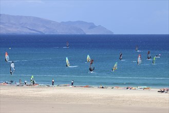 Windsurfers in the turquoise waters off the Playa Risco del Paso beach