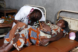 Pregnant woman being examined by a doctor