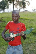 Boy playing on a home-built guitar
