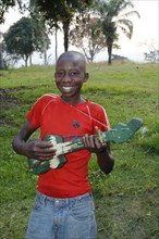 Boy playing on a home-built guitar