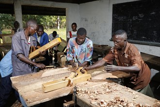Apprentices planing wood