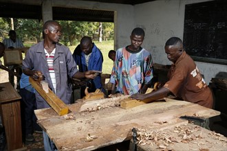 Apprentices planing wood