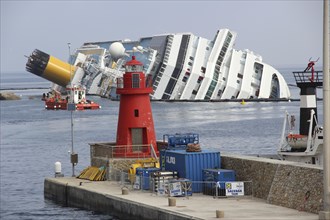Damaged cruise ship Costa Concordia laying in Giglio Porto harbour