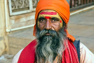 Portrait of a Rajasthani man with orange turban and beard